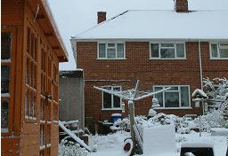 Click for larger image (1,500×1,024) House now clearly visible through light snowfall.