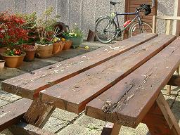 Click for larger image (1,024×768) Picnic table split and weathered with my mountain bike in background.