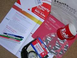 Click for larger image Goody bag from the award, featuring: event programme, branded pens, cup, notepad, mousepads and tyre pressure guage.