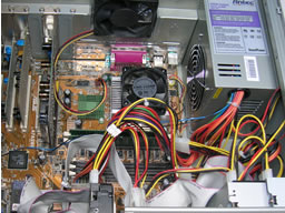 Click for larger image Power unit intake fan aligns with CPU exhaust. Case fan operates perpendicularly to them. A tight tangle of ribbon cables flow between the power lines.