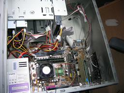 Click for larger image Wide view shows CPU is central with power supply above, various drives in front, various cards below and case fan behind.