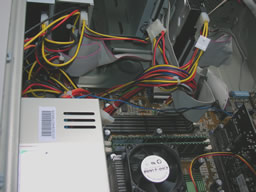 Click for larger image Close view of a power line jumping from DVD to CD to floppy drive. Hard drive uses a separate line.
