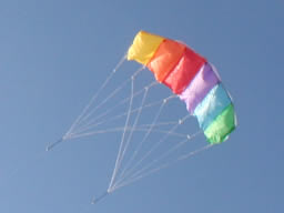 Mini power kite way up in the sky.