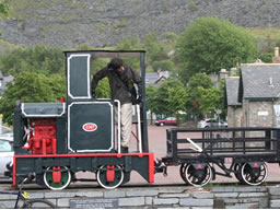 Narrow mining train on a plinth, with me on the footplace looking back at a mining cart.