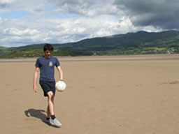 Me playing &lsquo;keepy-uppy&rsquo; on the sand.