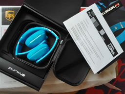 Unboxed headphones with the oversized UPS delivery box, various inner boxes with cyan cables and headphones.