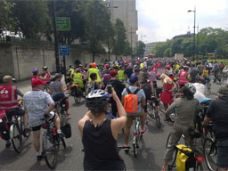 Elevated view amongst the hundreds of cyclists parading down a closed London street.