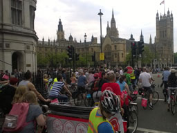 The parade passes the lacey stonework of the Houses of Parliament. Street sign says: “PARLIAMENT STREET SW1”