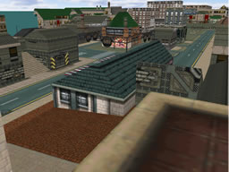 Click to view large image A pizzeria on dark red pavement is in foreground, with factories and warehouses lining roads in the background.